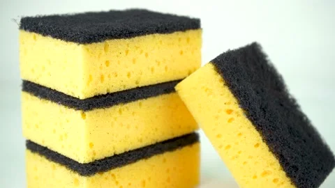 Stack of yellow dishwashing sponges isolated on white background Stock Footage 139114459