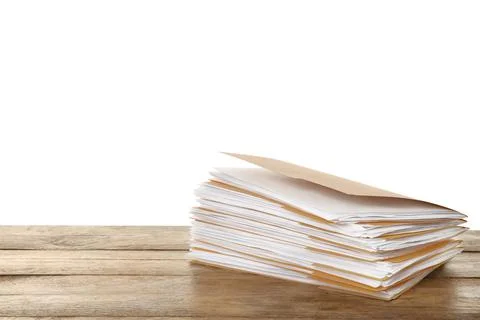 Stack of yellow files with documents on wooden table against white background Stock Photos