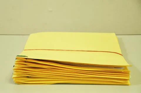 Stack Of Yellow Folders On The Table Stock Photos