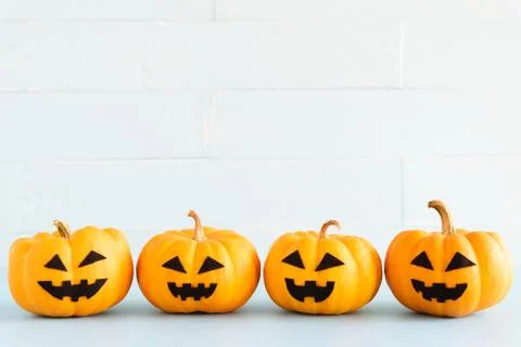 Stack of yellow ghost pumpkin on white brick block background. halloween conc 스톡 사진
