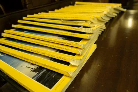 Stack of yellow magazines old an worn lined up Stock Photos
