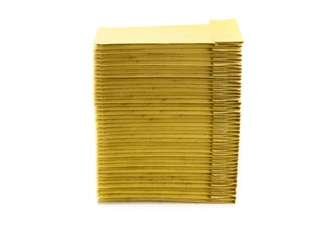 Stack of yellow padded envelopes isolated on white Foto stock