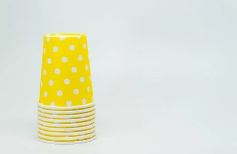 Stack of Yellow paper cup on white background and selective focus Stock Photos