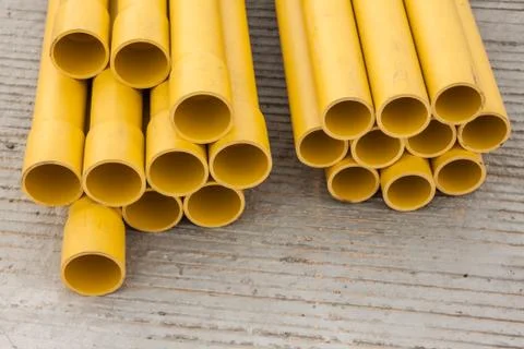 Stack of yellow PVC pipes Stock Photos