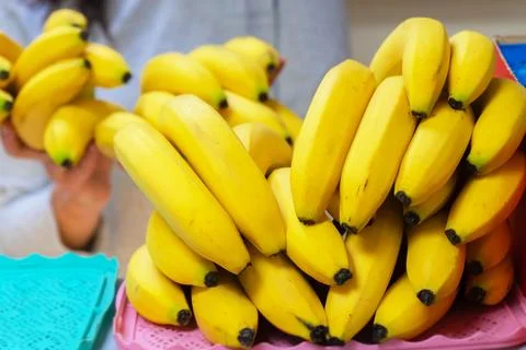 A stack of yellow ripe bananas on a store counter. 스톡 사진