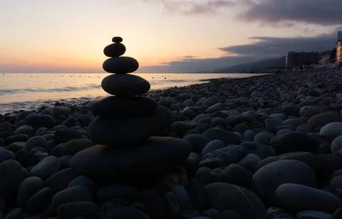 Stack of zen stones on the beach at sunset, beautiful seascape. Made of stone Stock Photos