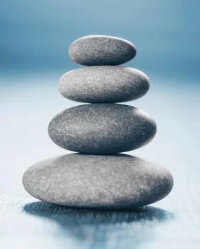 Stack of Zen Stones on blue background. Stock Photos