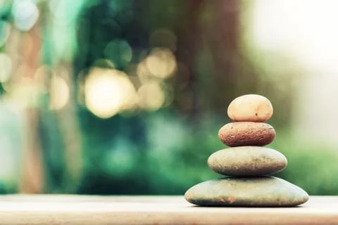 Stack of zen stones on ground with blurred nature background. Stock Photos