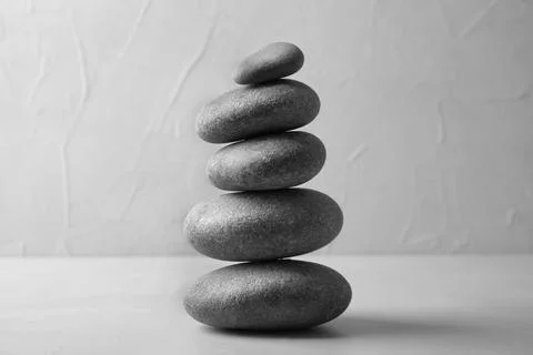 Stack of zen stones on table against light background 스톡 사진