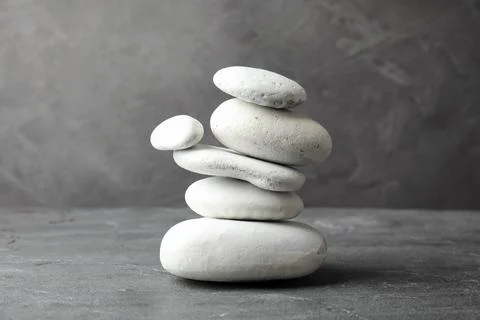 Stack of zen stones on table against grey background 스톡 사진