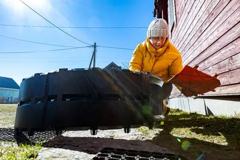 Stackable compost container taking shape while rural woman connects interlo.. Stock Photos
