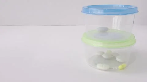 Stackable pill organizer box rotating with daily doses of medicine for a we.. Stock Footage 335141505