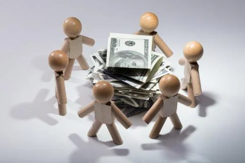 Stacked Banknotes Surrounded By Human Figures Stock Photos