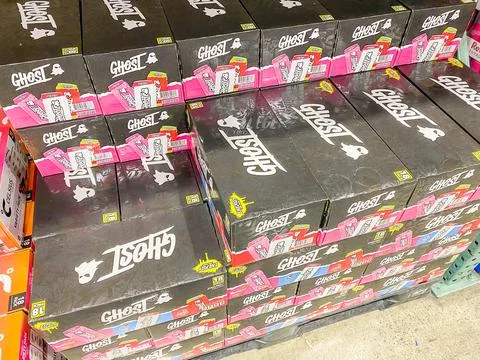 Stacked black boxes of Ghost Energy drinks on display in a warehouse retail s Fotos Stock