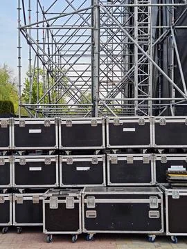 Stacked black flight cases on wheels for concert equipment Stock Photos
