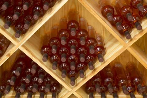 Stacked bottles of grape wine in a wine cellar Stock Photos