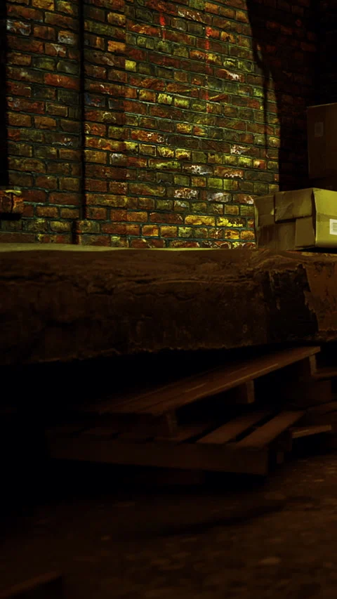 Stacked boxes and wooden pallets in a warehouse at night in an urban setting Stock Footage 334724443