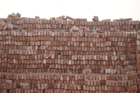 Stacked bricks at a construction site in the early morning light Stock Photos