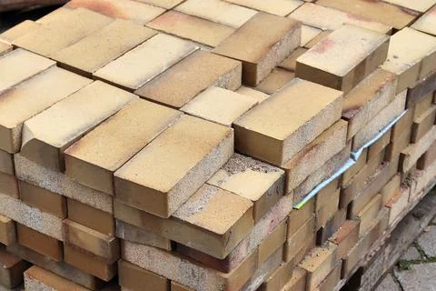 Stacked bricks on pallet representing construction and building material Stock Photos