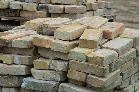Stacked Bricks Ready for Use at a Construction Site During Daylight Hours N.. Stock Photos