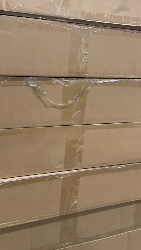 Stacked brown cardboard shipping boxes displayed on retail store shelves for Stock Footage 345179561