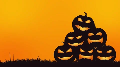 Stacked carved pumpkins glowing at sunset in autumn field with warm gradient sky Video stock 346068134