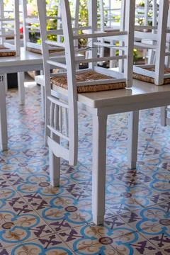Stacked Chairs on Patterned Floor Stockfoto's