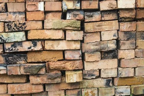 Stacked clay bricks showcasing a rustic texture and earthy colors at a cons.. Stock Photos