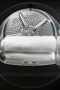 Stacked clean white towels inside washing machine drum. Clean concept.Laundry Stock Photos