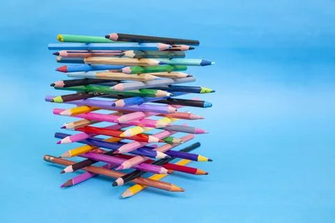 Stacked colored crayons stacked in the shape of a high tower illuminated  o.. Stock Photos