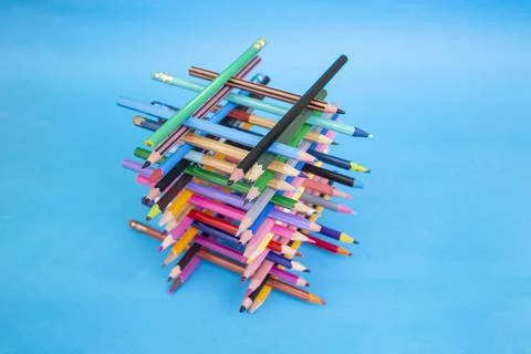 Stacked colored crayons stacked in the shape of a high tower illuminated  o.. Foto stock