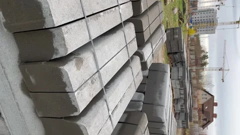Stacked concrete blocks in a construction yard, showcasing the texture and Stock Footage 320874035