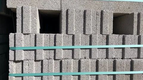 Stacked concrete blocks with teal straps creating geometric pattern backgroun Stock Footage 328969136