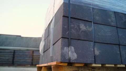 Stacked concrete blocks wrapped in plastic on pallet at construction site Stock Footage 337544862