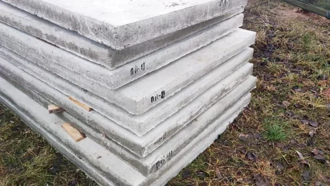Stacked concrete slabs ready for construction project outdoors, gray building Stockbeeldmateriaal 342921063