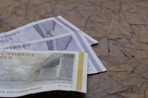 Stacked danish banknotes of different denomination on the brown table Stock Photos