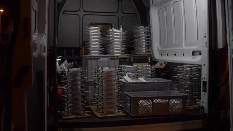 Stacked drones in a van for a high-tech lightshow event preparation Stock Footage 298188478