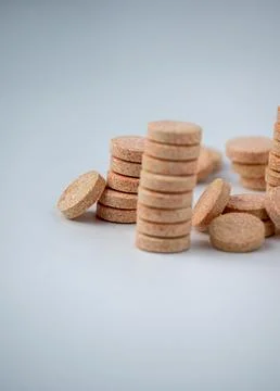 Stacked Effervescent Vitamin C Tablets on Blue Background Stock Photos