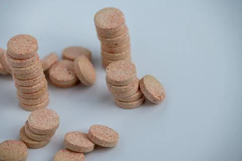 Stacked Effervescent Vitamin C Tablets on Blue Background Stock Photos