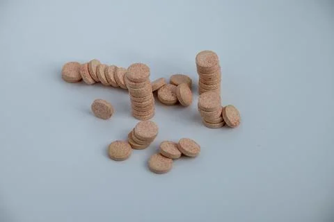 Stacked Effervescent Vitamin C Tablets on Blue Background Stock Photos