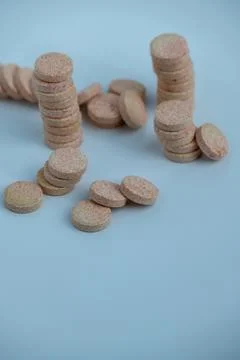 Stacked Effervescent Vitamin C Tablets on Blue Background Stock Photos