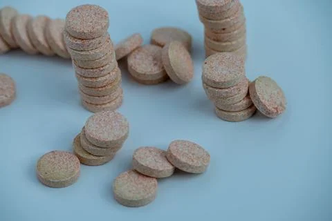 Stacked Effervescent Vitamin C Tablets on Blue Background Stock Photos