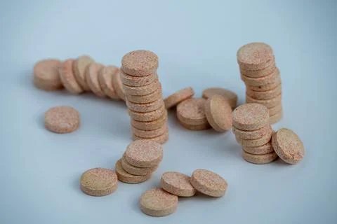 Stacked Effervescent Vitamin C Tablets on Blue Background Stock Photos