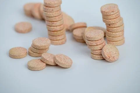 Stacked Effervescent Vitamin C Tablets on Blue Background Stock Photos