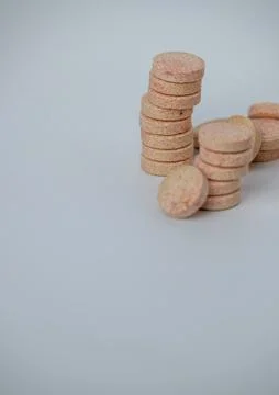 Stacked Effervescent Vitamin C Tablets on Blue Background Stock Photos
