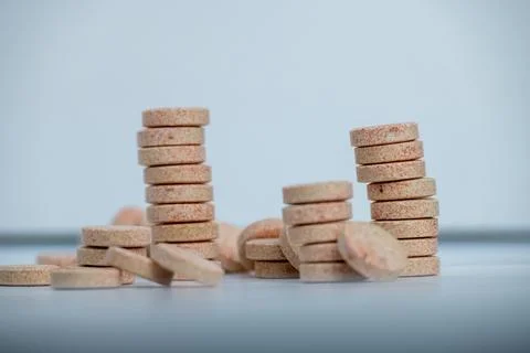 Stacked Effervescent Vitamin C Tablets on Blue Background Stock Photos
