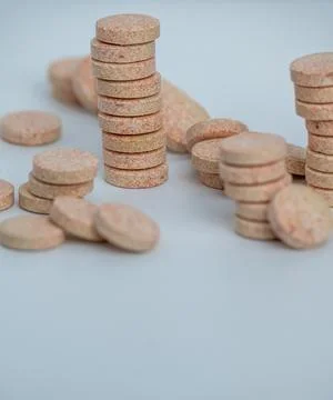 Stacked Effervescent Vitamin C Tablets on Blue Background Stock Photos