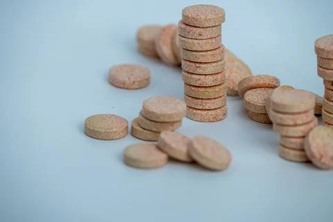 Stacked Effervescent Vitamin C Tablets on Blue Background Stock Photos