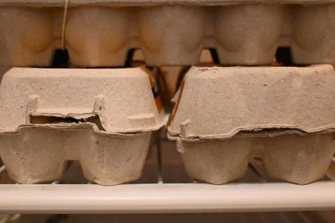 Stacked egg cartons on a shelf Stockfoto's
