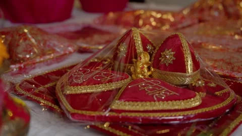 Stacked embroidered wedding gift boxes with golden Ganesh figurine Stock Footage 342396201